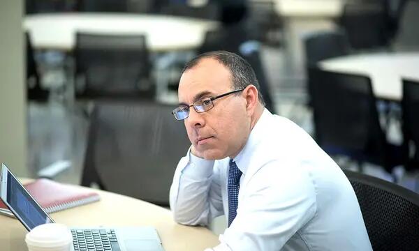 A man with a laptop and coffee