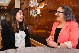 female mentor speaking with female to student