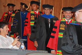 doctoral students processing during graduation