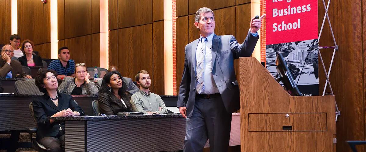 Ted Baker presents to an audience within Bove auditorium on the Newark campus