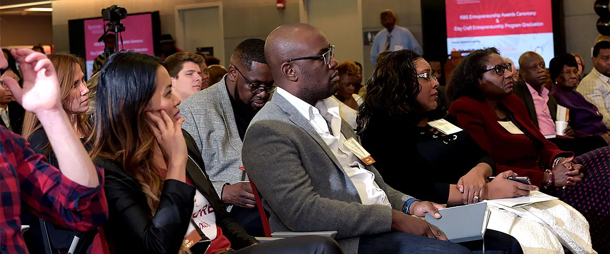 The crowd at a CUEED event listening to a speaker