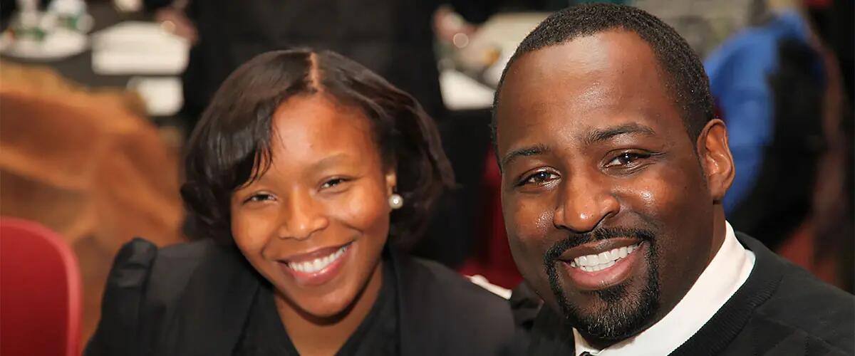 A man and woman smiling for the camera at an EPI event