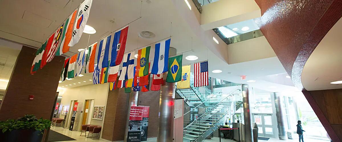 Indoor view of 1 Washington park's lobby with flags from many different countries displayed from the ceiling. 