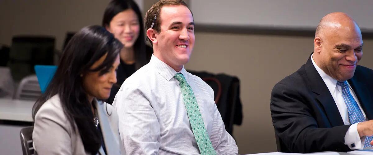 Students smiling while sitting in class