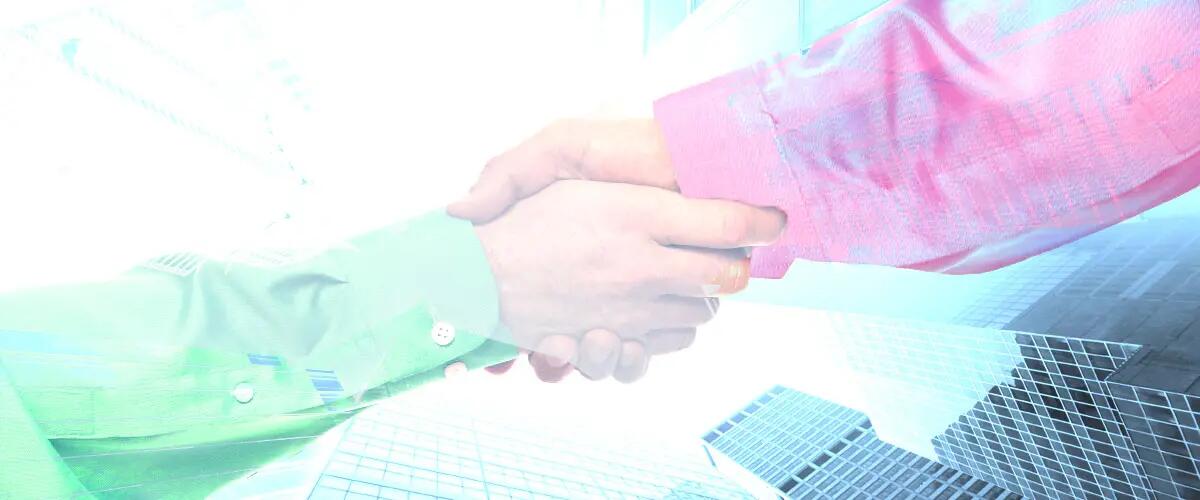 A handshake over a cityscape background