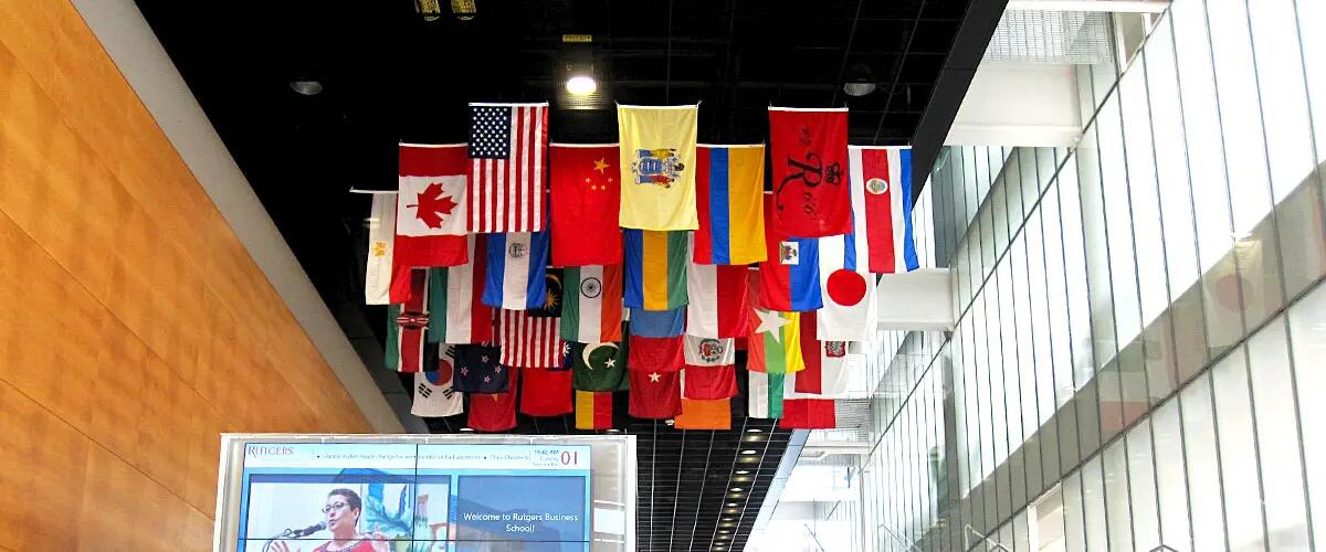 Inside shot of the staircase at 100 Rock with various countries' flags haning from the ceiling.
