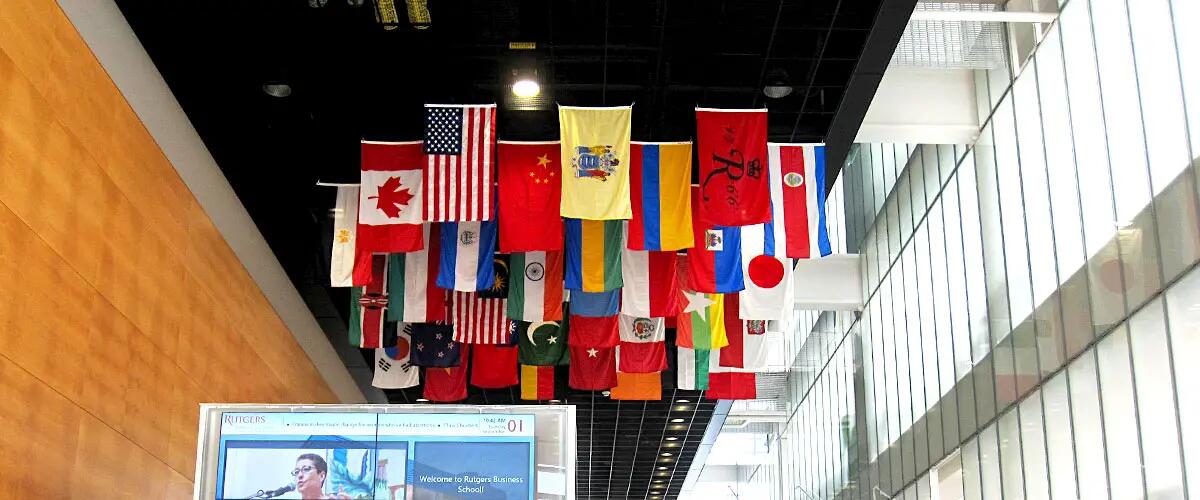 Inside shot of the staircase at 100 Rock with various countries' flags haning from the ceiling.